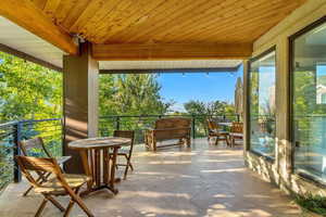 View of patio with a balcony