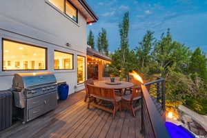 Wooden terrace with grilling area and outdoor dining area