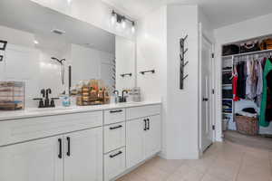 Bathroom with tile patterned flooring, a sink, and visible vents
