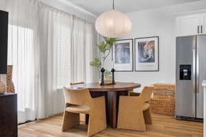 Dining area with plenty of natural light and light wood-style floors