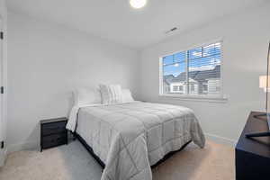 Bedroom with baseboards, carpet flooring, and visible vents