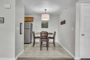 Dining space featuring baseboards and visible vents