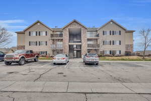 View of property with uncovered parking