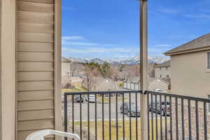 Balcony featuring a residential view and a mountain view