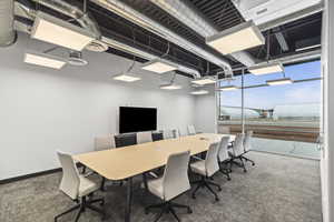 Carpeted office space with baseboards