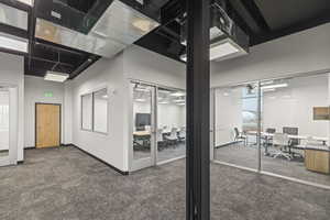 Interior space featuring baseboards and a high ceiling
