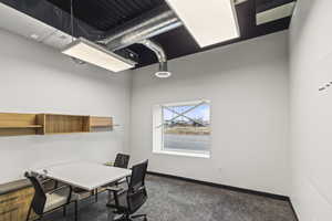 Carpeted office featuring baseboards