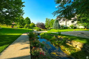 View of home's community with a yard