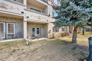 Back of property featuring stucco siding and a patio