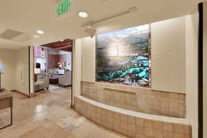 Interior space with baseboards, visible vents, and stone tile flooring