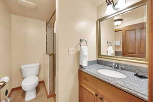 Bathroom with visible vents, baseboards, toilet, tile patterned floors, and vanity