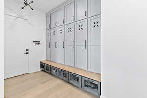 Mudroom area with custom lockers and pull out drawers