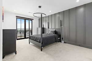Bedroom with a decorative wall, visible vents, recessed lighting, access to exterior, and light colored carpet