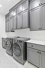 Laundry area with washing machine and clothes dryer and cabinet space