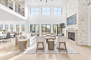 Living area with light wood finished floors, a fireplace, and recessed lighting