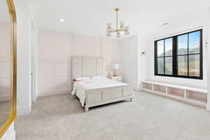 Bedroom featuring an inviting chandelier, recessed lighting, and light carpet