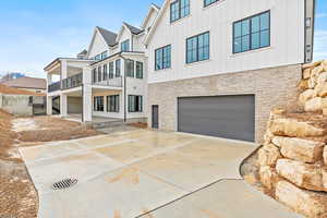 Back of home with access to second garage space