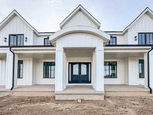 Front entry way with covered porch and board and batten siding
