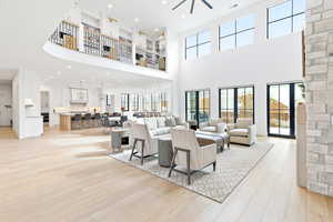 Living area featuring recessed lighting, upstairs loft overlooking, and a ceiling fan