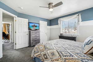 Carpeted bedroom with a closet and ceiling fan