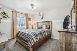 Carpeted bedroom featuring baseboards