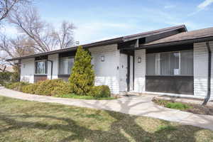 Single story home featuring a front lawn and brick siding