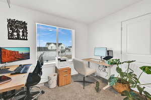 Carpeted office space featuring baseboards