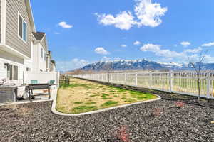 View of yard with a mountain view and a fenced backyard