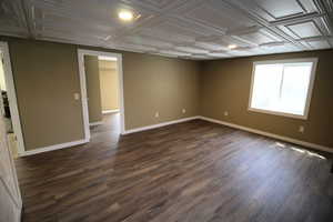 Spare room with recessed lighting, dark wood-style flooring, an ornate ceiling, and baseboards