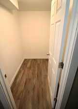 Spacious closet with dark wood-style floors