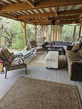 View of patio with an outdoor living space and a wooden deck
