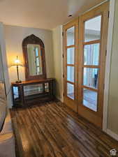 Doorway with visible vents, baseboards, and wood finished floors
