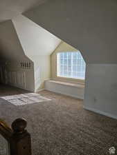 Bonus room with carpet, baseboards, and lofted ceiling