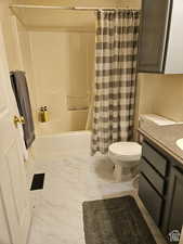 Full bathroom with vanity, toilet, shower / bathtub combination with curtain, visible vents, and marble finish floor