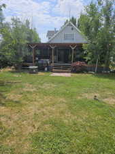 Back of house featuring a yard