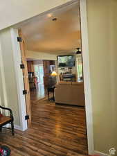 Hall with baseboards and dark wood finished floors