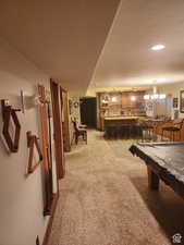 Playroom with recessed lighting, light carpet, and a notable chandelier