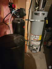 Utility room featuring secured water heater