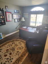 Home office featuring baseboards and wood finished floors