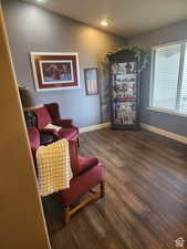 Living area with recessed lighting, wood finished floors, and baseboards