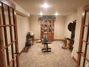 Exercise room with carpet flooring, french doors, and baseboards