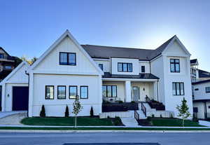 View of front facade featuring board and batten siding, a porch, a standing seam roof, metal roof, and brick siding