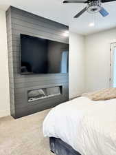 Primary bedroom mantel and electric fireplace (82 inch TV hanging)