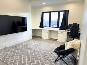 Tech Room with built in desk, recessed lighting, and light tile patterned floors with 10 ft ceilings