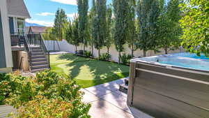 View of yard featuring a fenced backyard and a hot tub