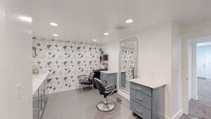 Home office featuring visible vents, an accent wall, and recessed lighting