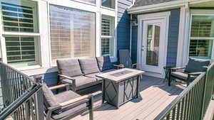 Wooden terrace with an outdoor living space with a fire pit