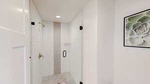 Full bath featuring a shower stall