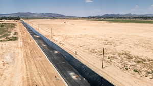 Overview of rural landscape with a mountainous background and a desert landscape