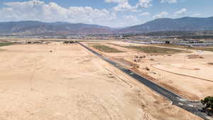 View of rural area featuring a mountain backdrop and a desert landscape